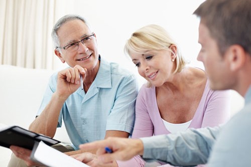 A mature couple talking to their financial advisor